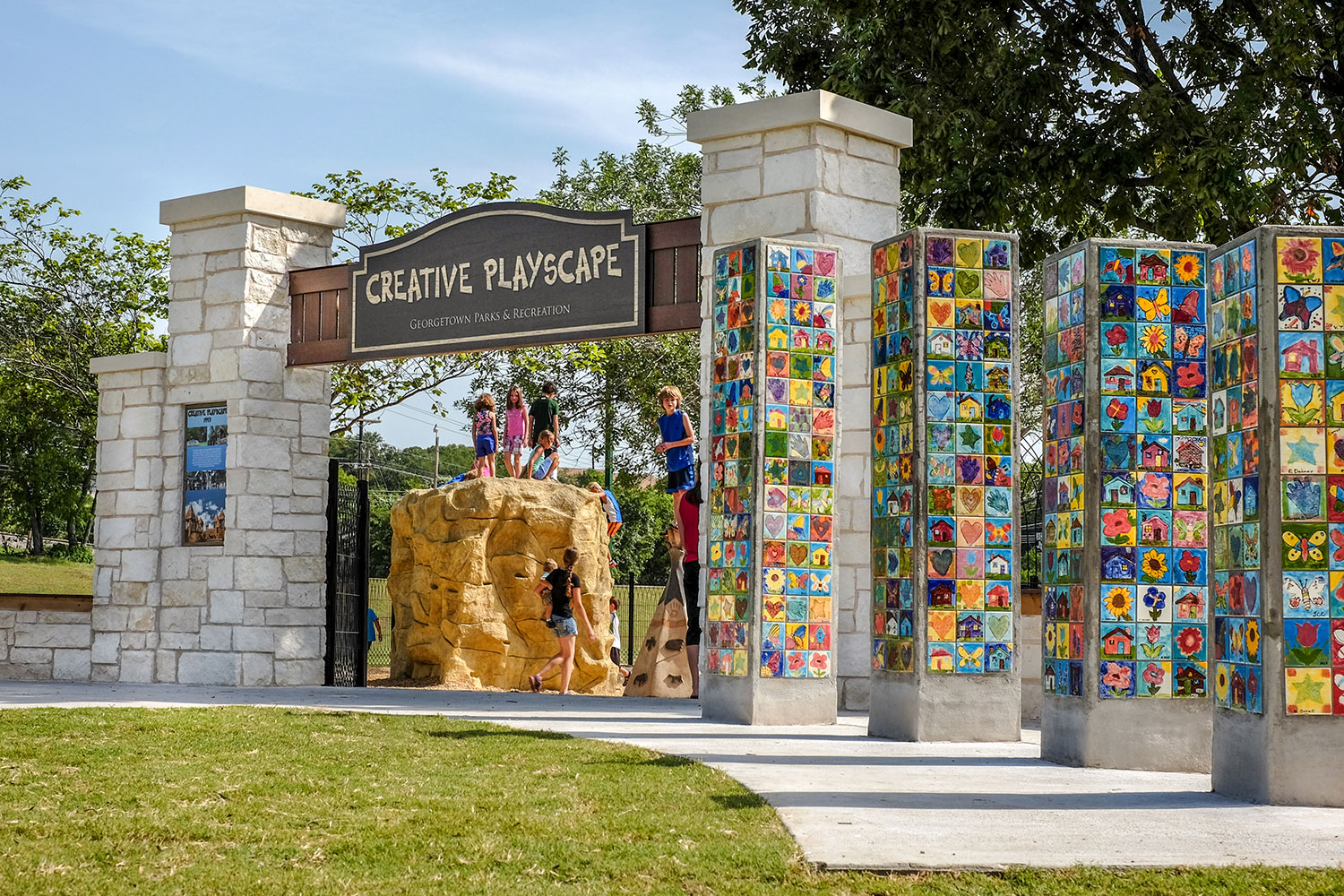Children playing at the entrance to the Creative Playscape in Georgetown, TX