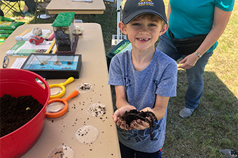 Boy holding worms at Garey Park in Georgetown, TX