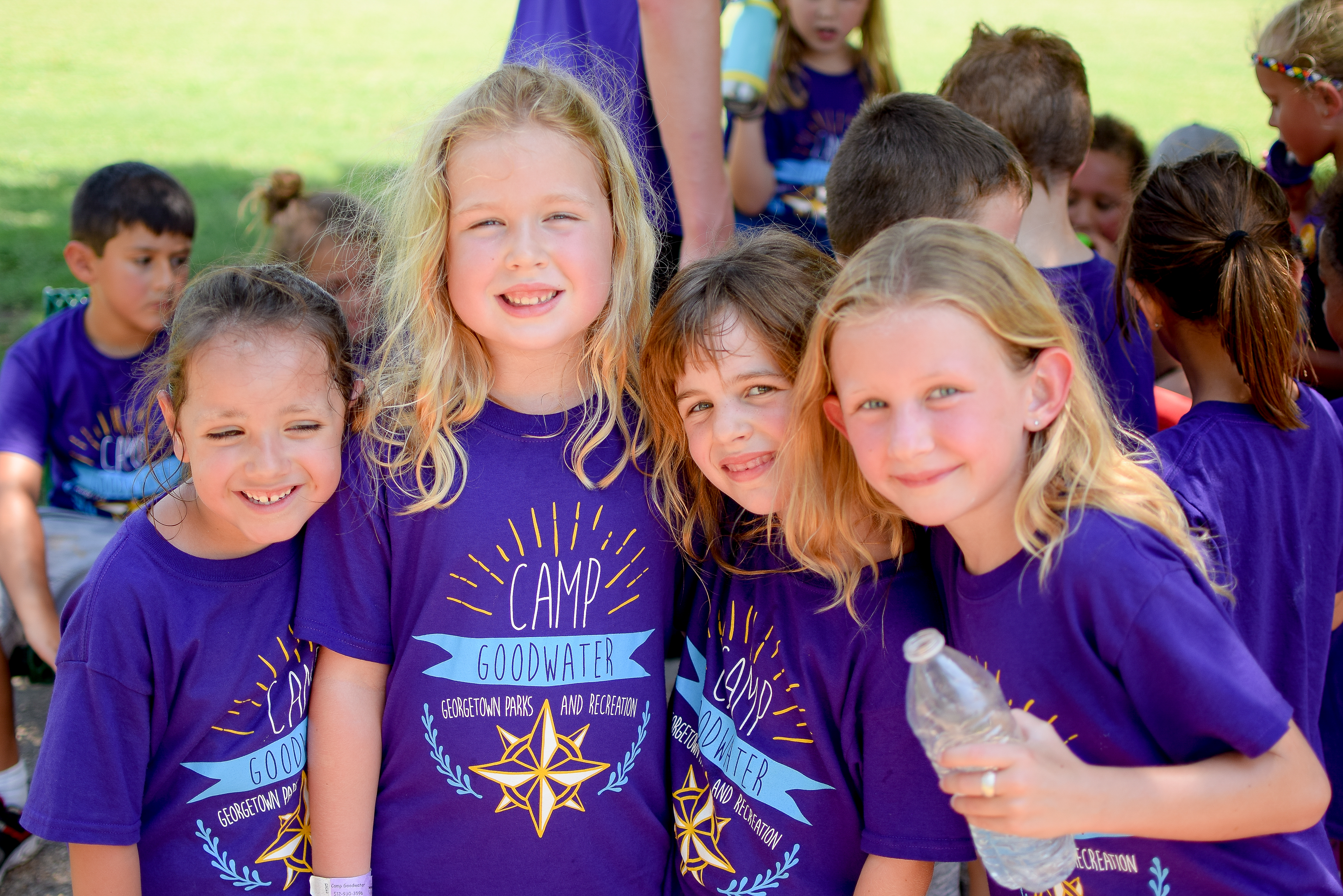 Four girls wearing purple Camp Goodwater shirts